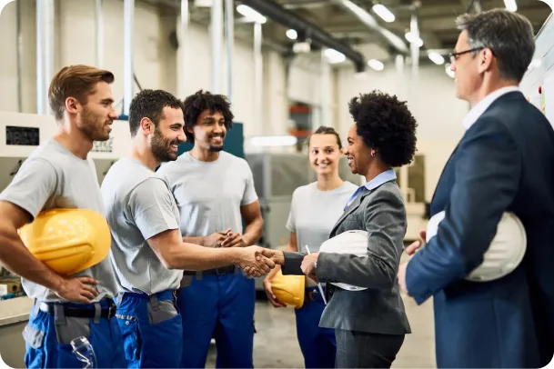 happy-african-american-manager-greeting-workers-handshaking-with-one-them-factory 1